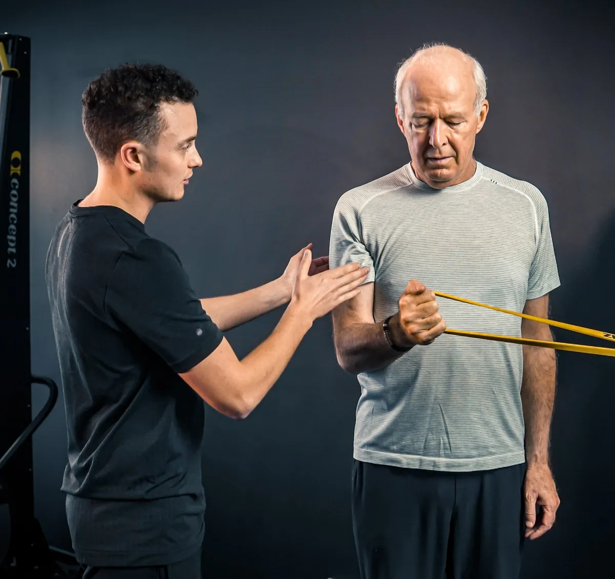 Siggy Brookland coaching a client through a shoulder rehab exercise